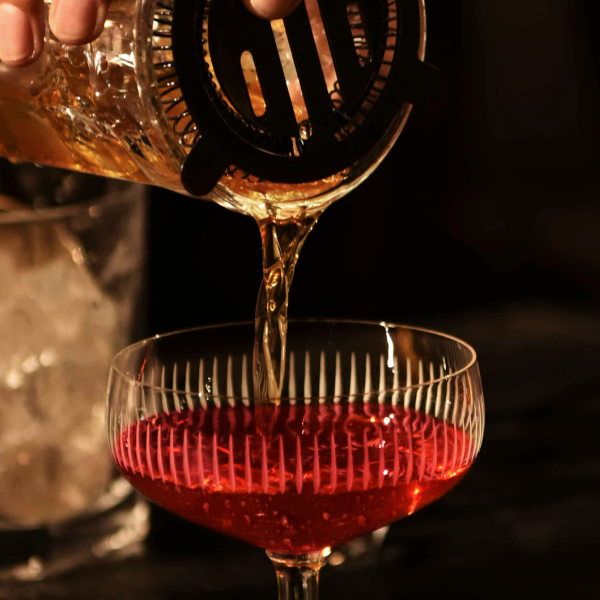 Rob Roy Cocktail being poured into a glass