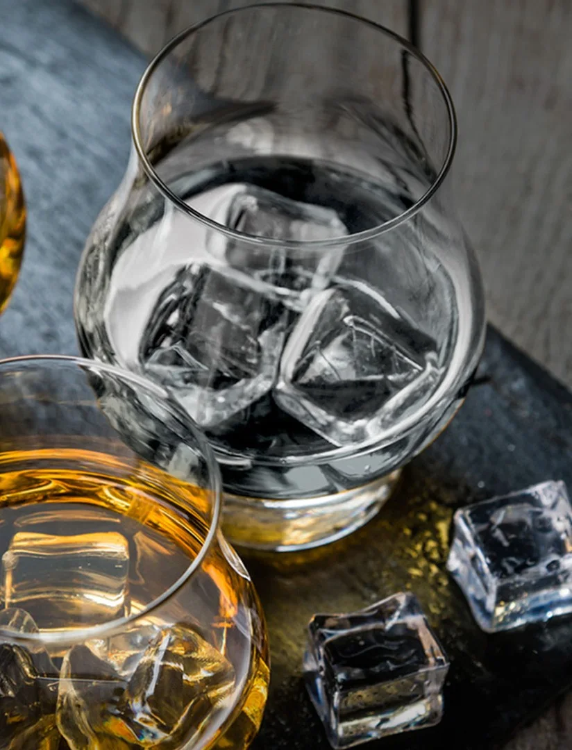 Close-up of whisky being poured into a glass during a tasting at a Speyside distillery.