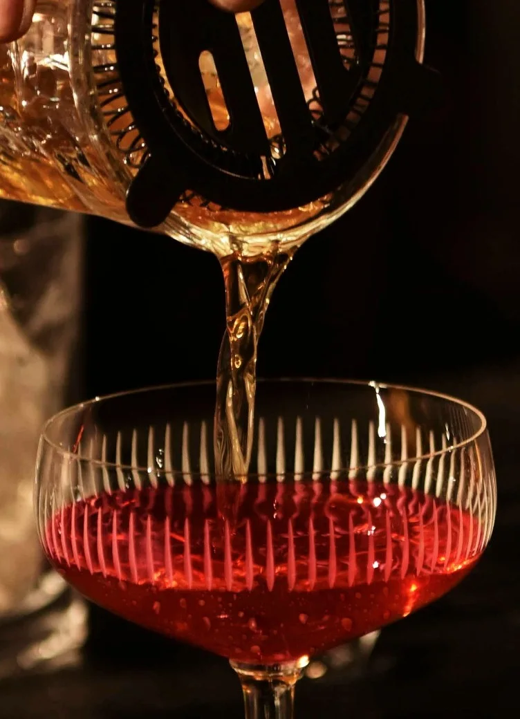 Rob Roy Cocktail being poured into a glass