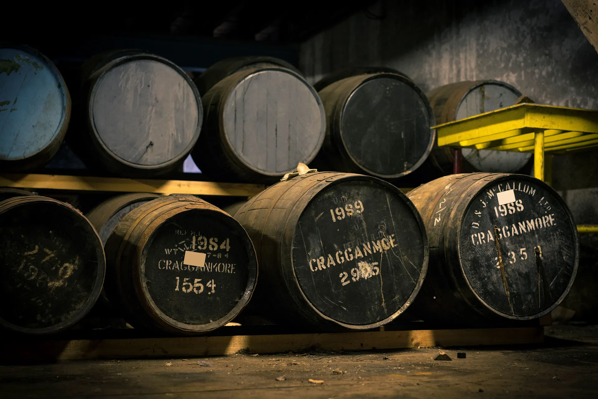 Room containing lots of wooden barrels stacked on top of each other