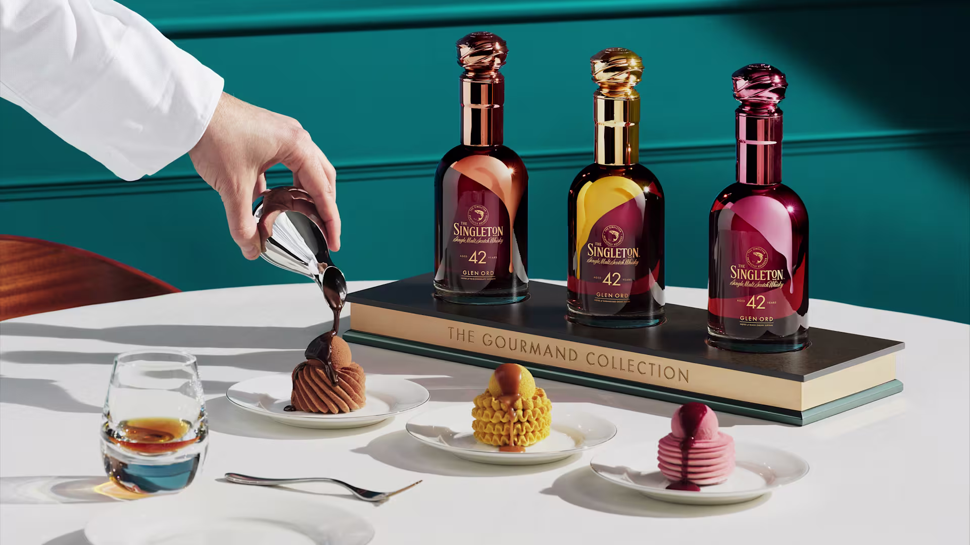 The Singleton Gourmand Collection bottles displayed with desserts and a glass of whiskey, highlighting the 42-year maturation story.