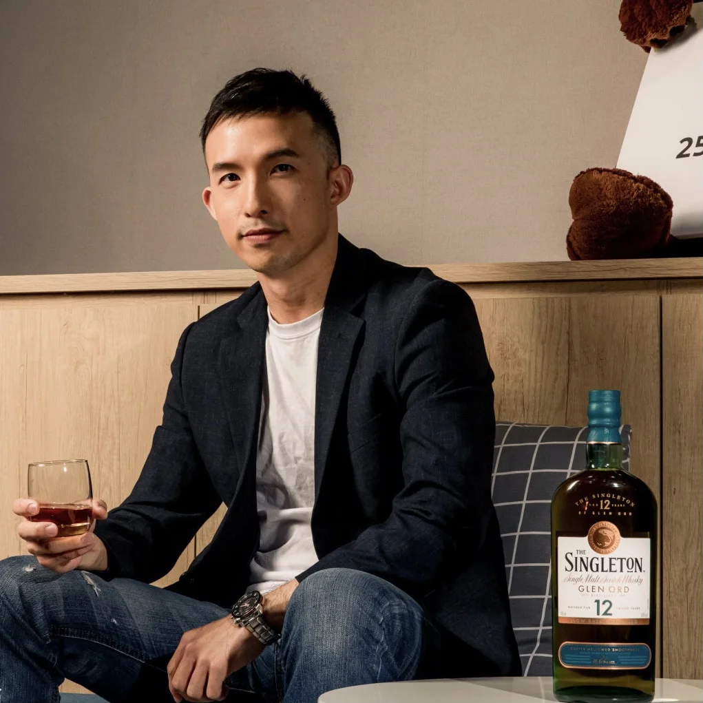 Man sitting with a glass of whisky