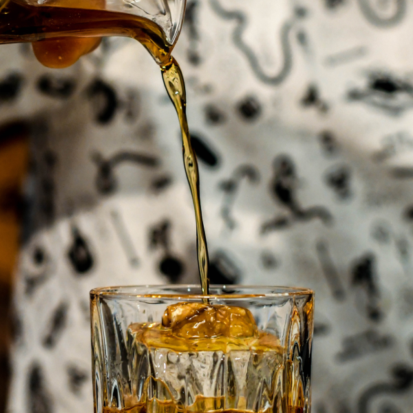 Rusty Nail Cocktail being poured into a glass