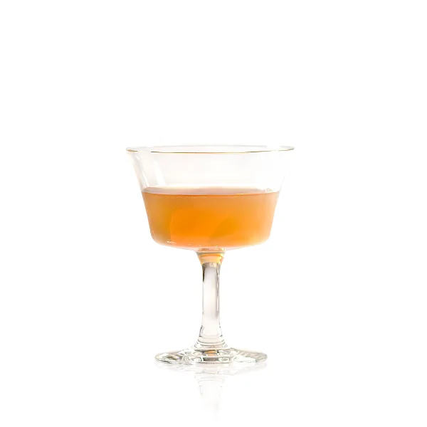  A light yellow cocktail in a coupe glass