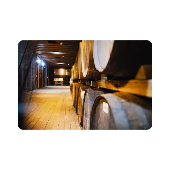 A well sit cellar containing many casks of the finest Glenkinchie whisky.