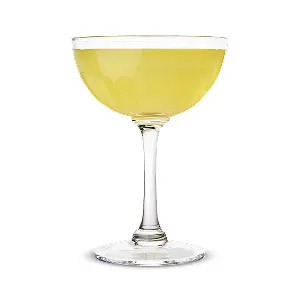 A light yellow cocktail in a coupe glass