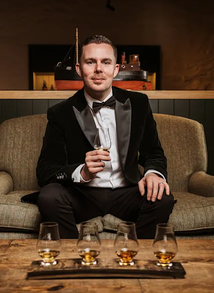 Jordan Paisley, Lagavulin Distillery Manager, sitting at the Islay distillery