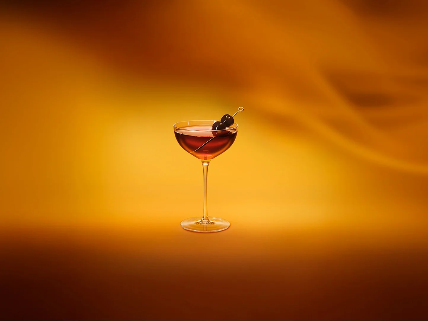 A Black Manhattan cocktail with a cherry garnish