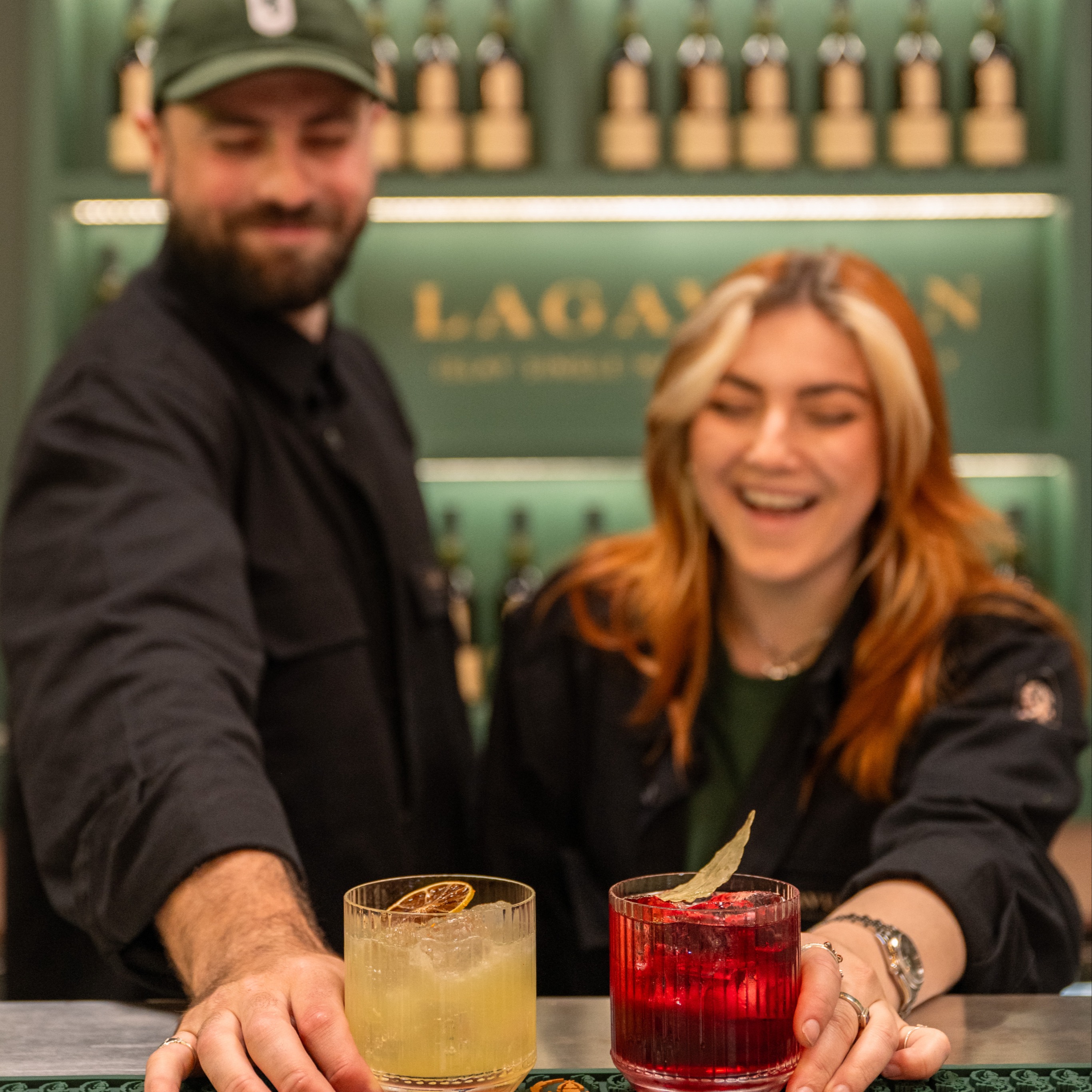 Lagavulin team members serving cocktails behind the bar