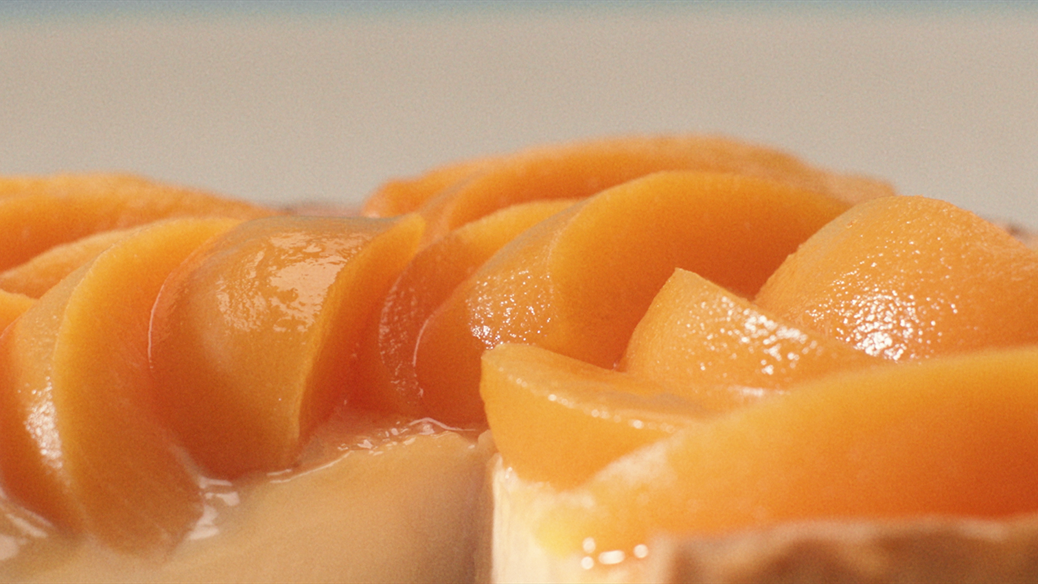 Glazed peach slices on a tart reflecting whisky’s sweet notes