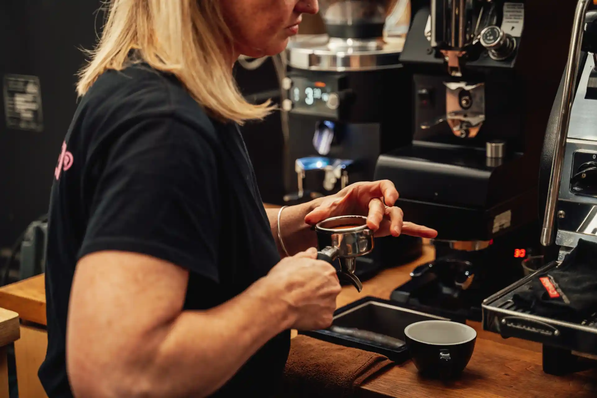 Lisa Lawson preparing a coffee at Dear Green Coffee.