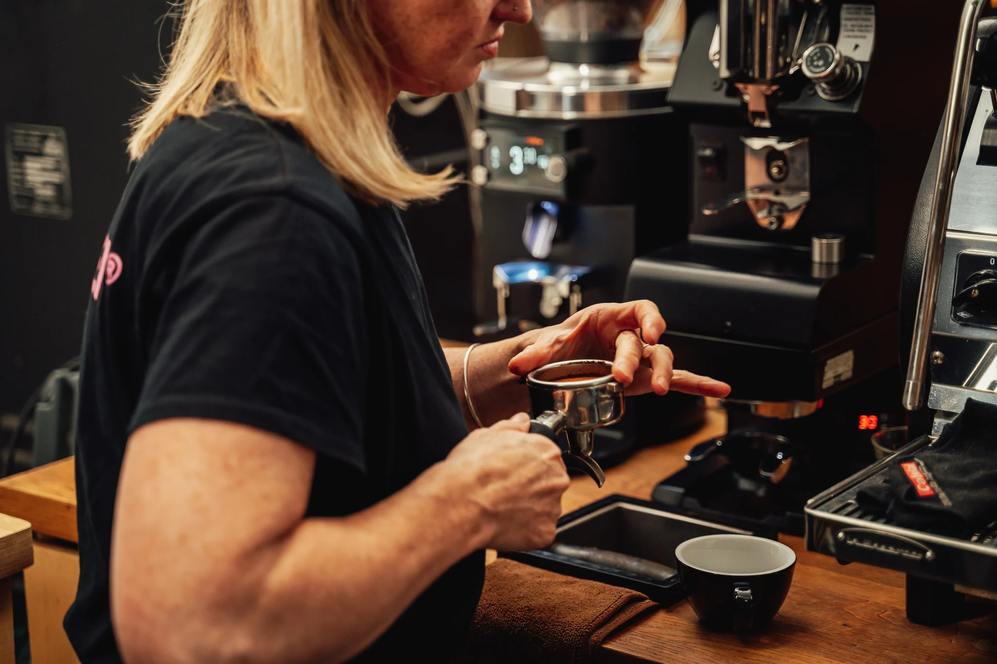 Lisa Lawson preparing a coffee at Dear Green Coffee.