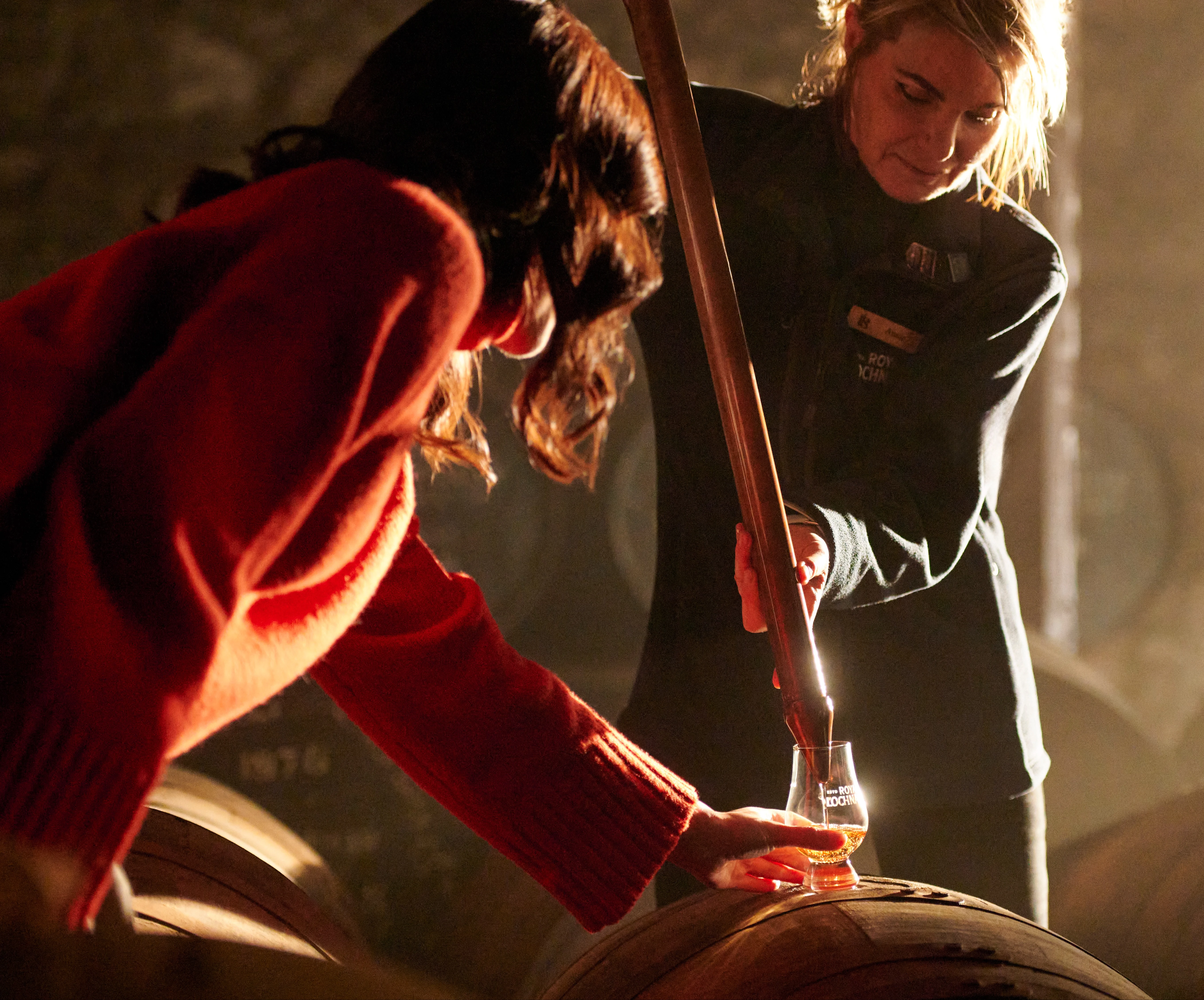 Two women inside a whisky distillery