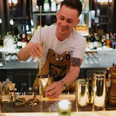 Whisky expert Ervin Trykowski tends a bar, making cocktails