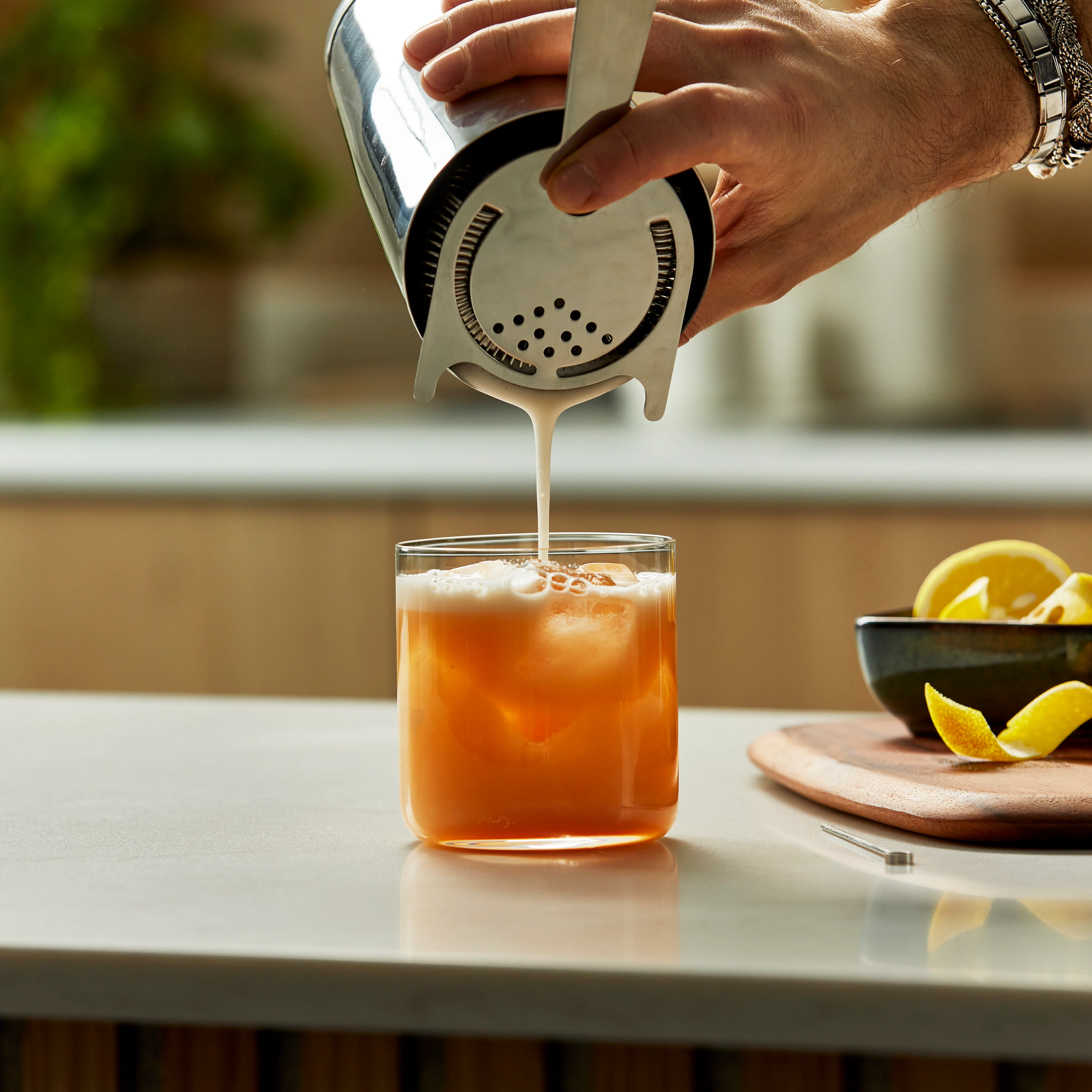 Whisky Sour Cocktail being poured into a glass