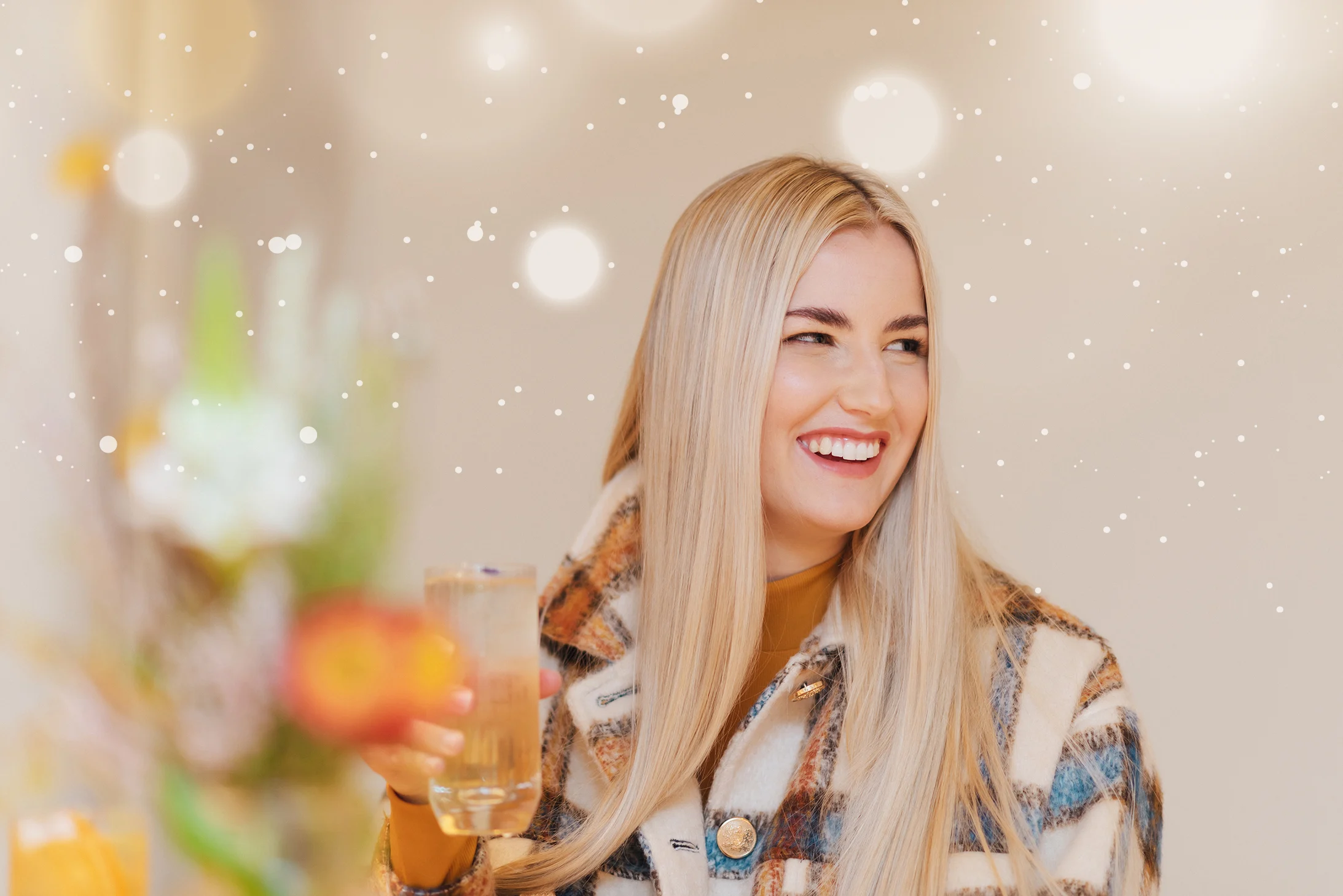 Blonde woman smiling and holding a delicious Glenkinchie cocktail 