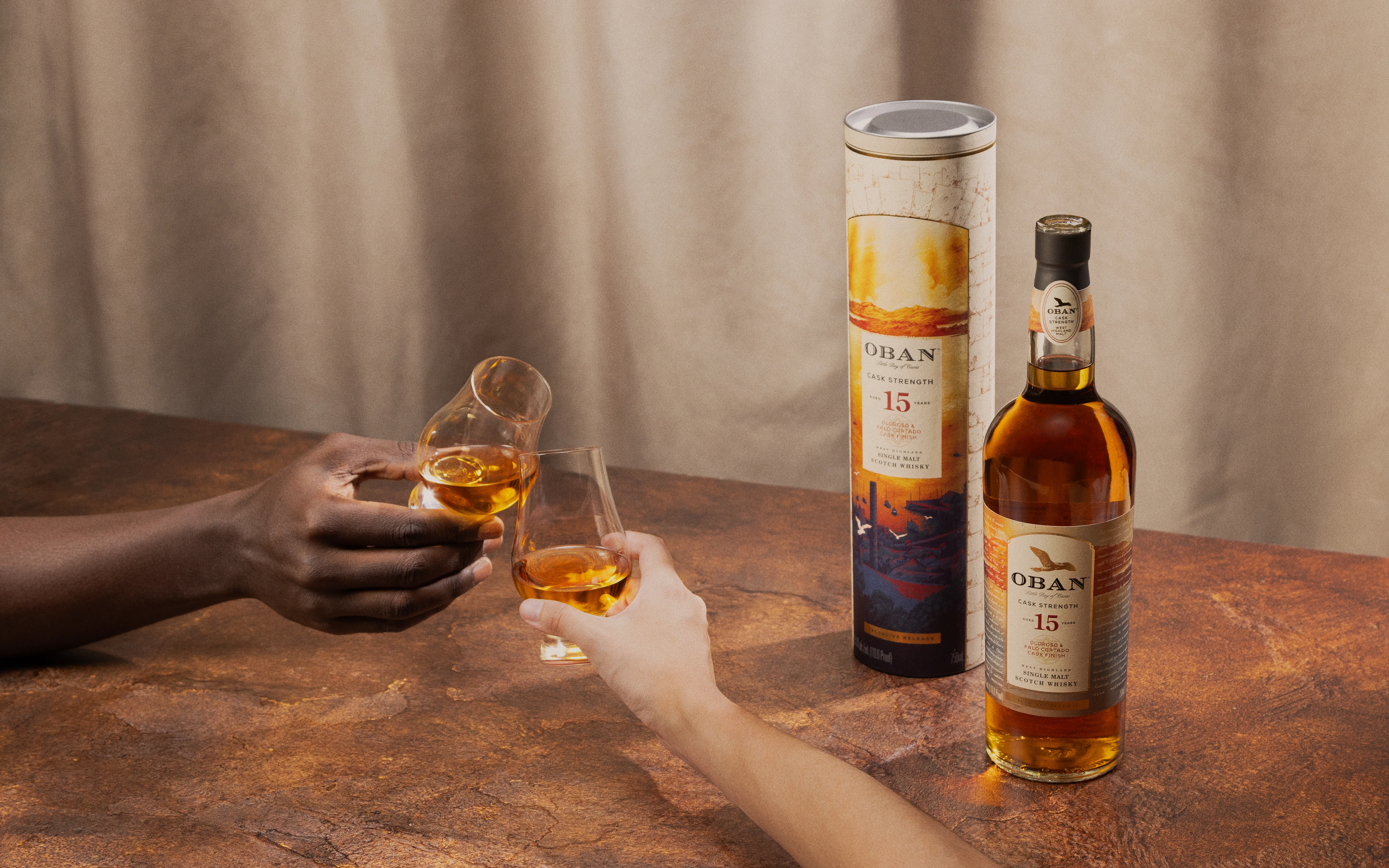 Two hands toasting with drams of Oban 15 Single Malt Scotch Whisky