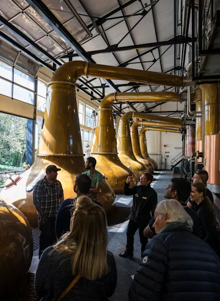 A group of people being given a guided tour of the The Singleton Distilleries