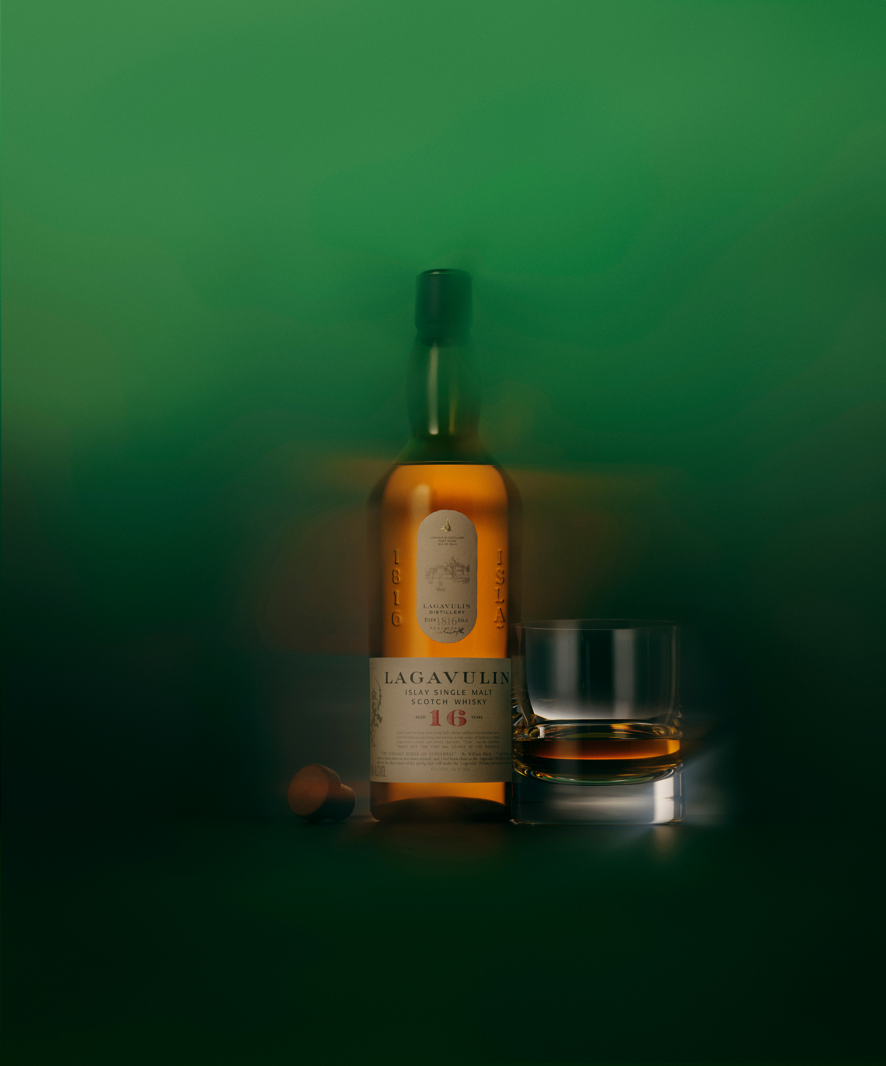 Lagavulin 16 Year Old bottle and glass in ethereal green mist
