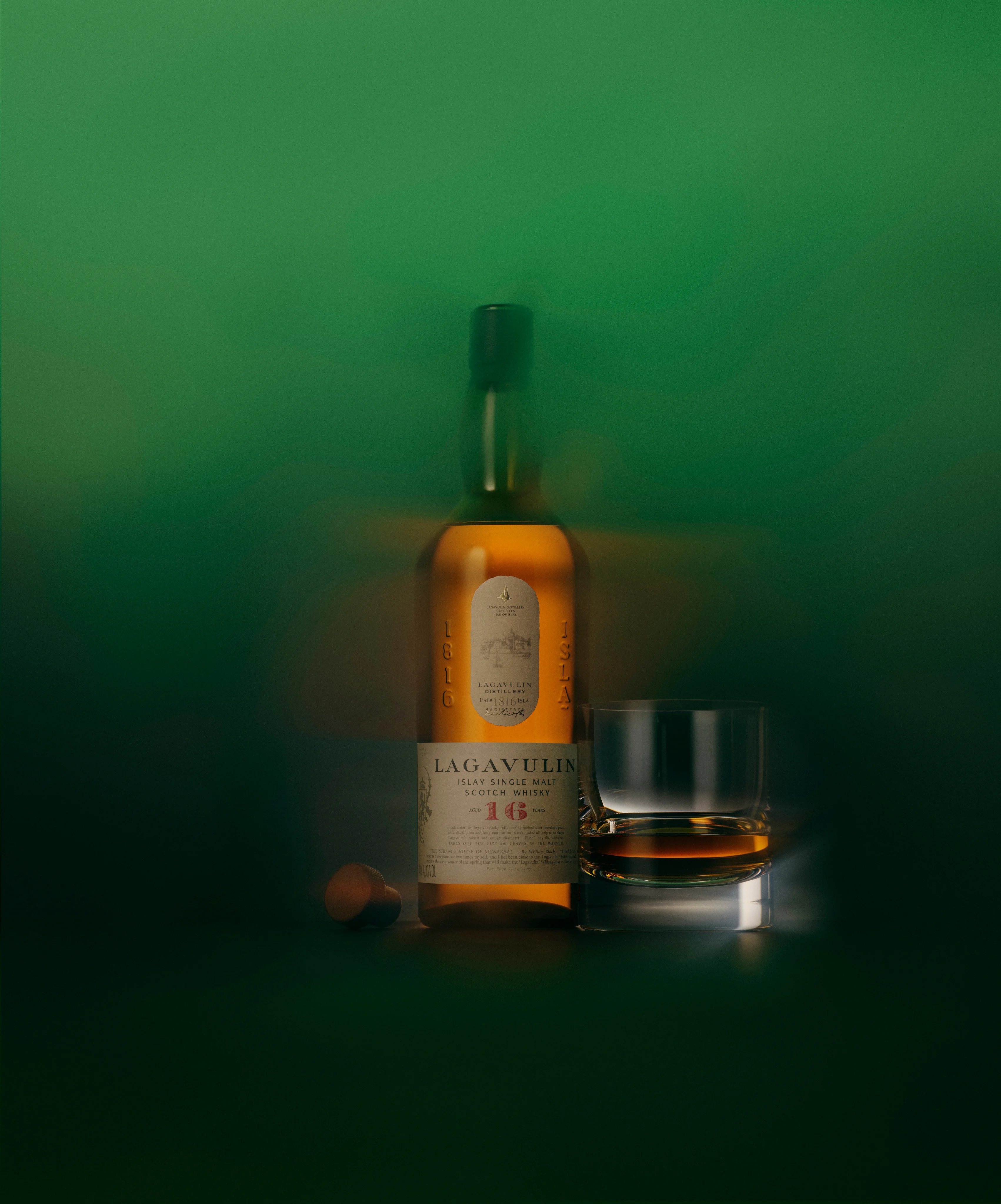 Lagavulin 16 Year Old bottle and glass in ethereal green mist