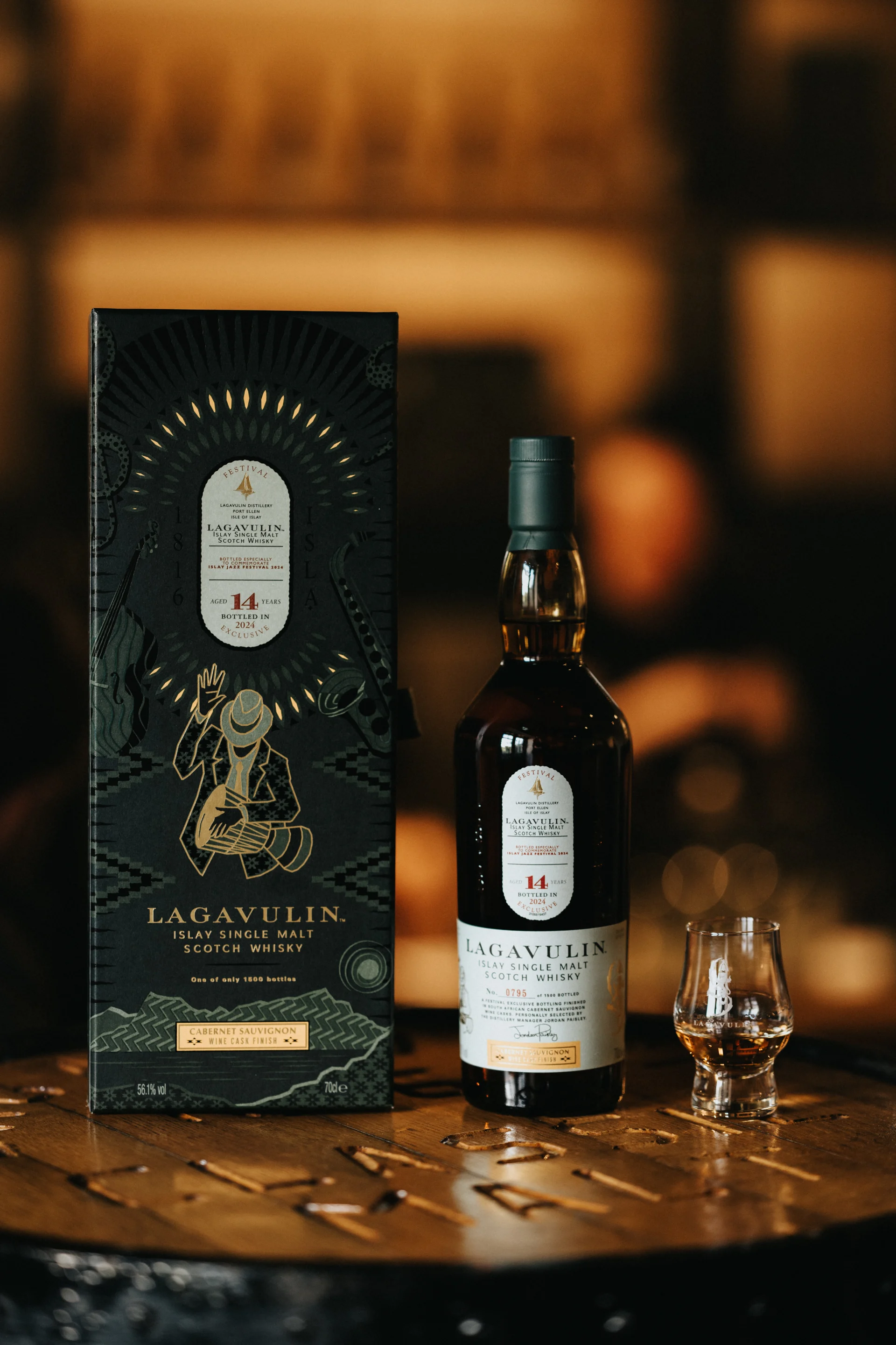 Lagavulin Jazz 2024 Image- Man playing Sax, Bottle and Rocks glass