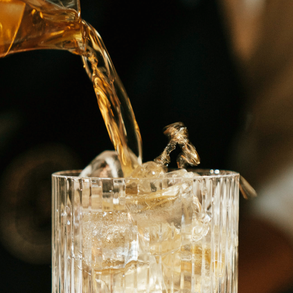 Sazerac Cocktail being poured into a glass