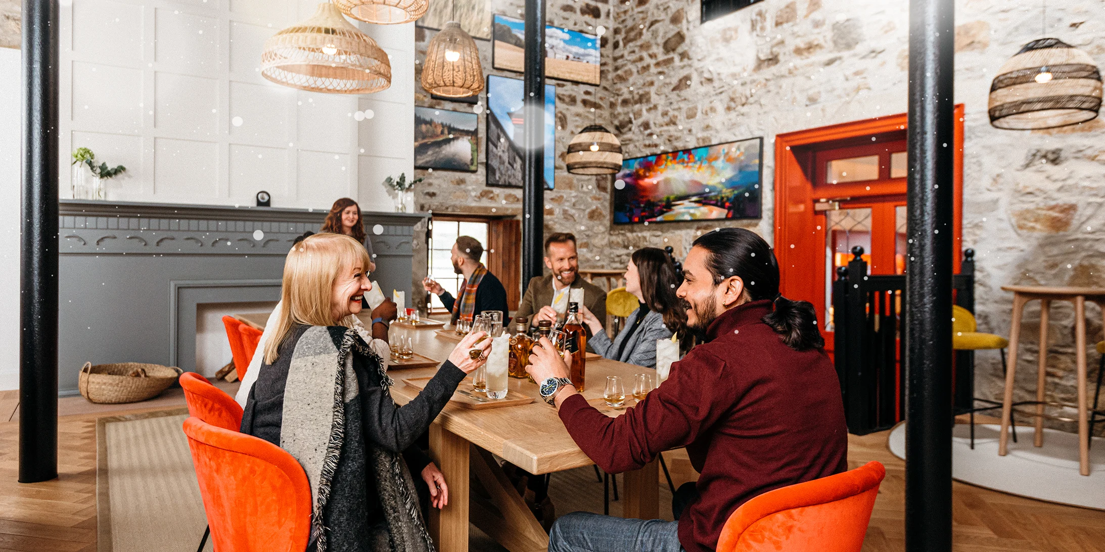 Group of happy visitors sitting around a rectangular table at Cardhu Distillery doing a tasting experience