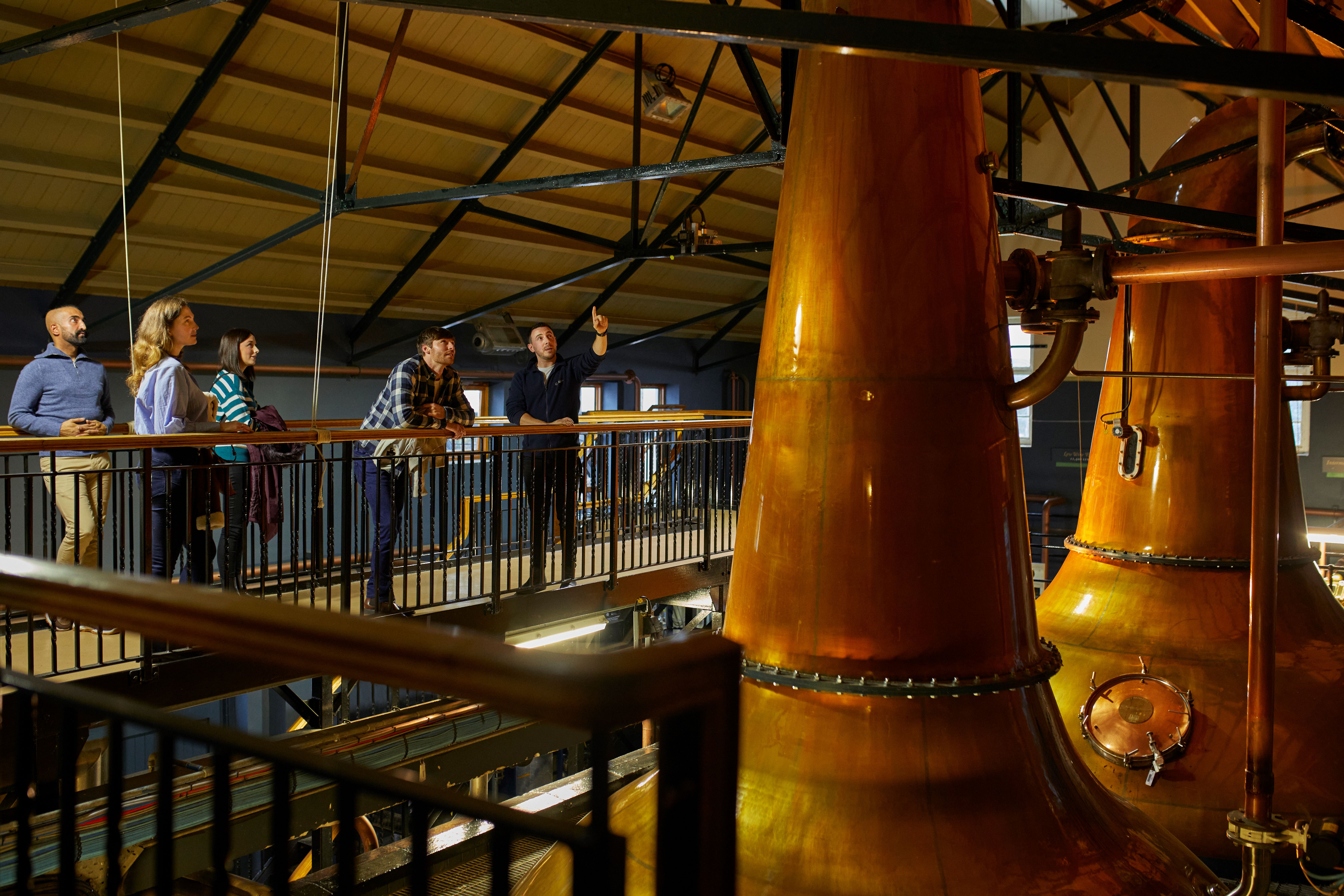 Group of people looking at the brewing process at Dalwhinnie Distillery
