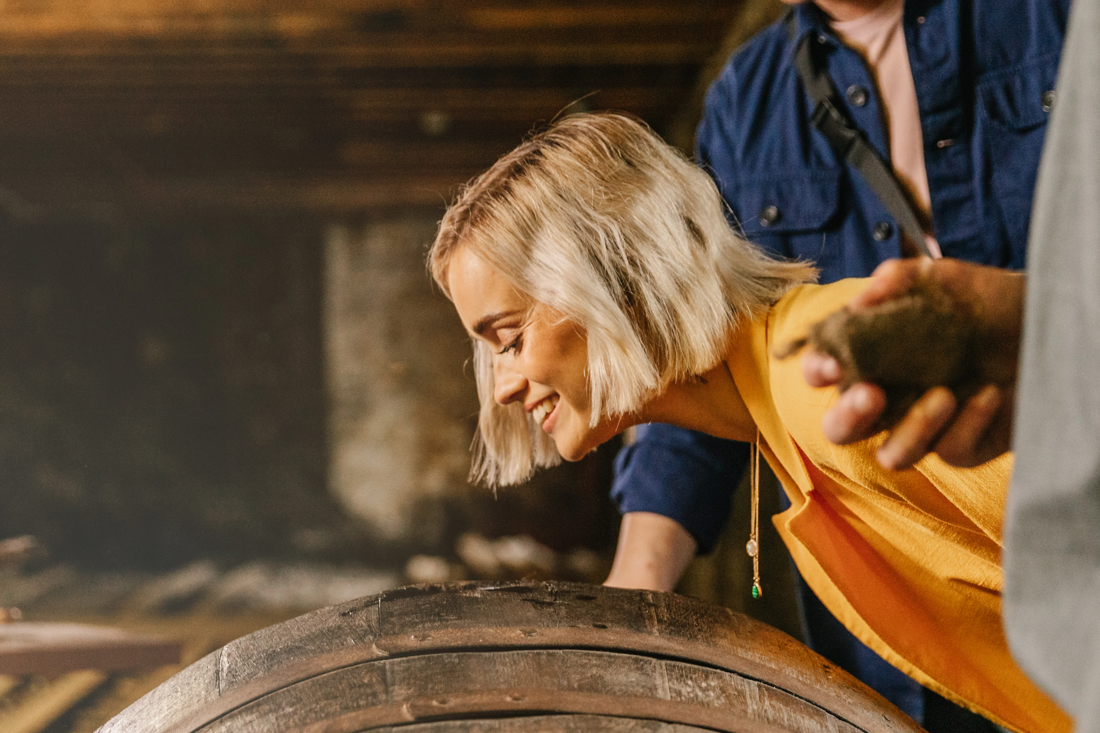Women smelling a cask at The Singleton distillery