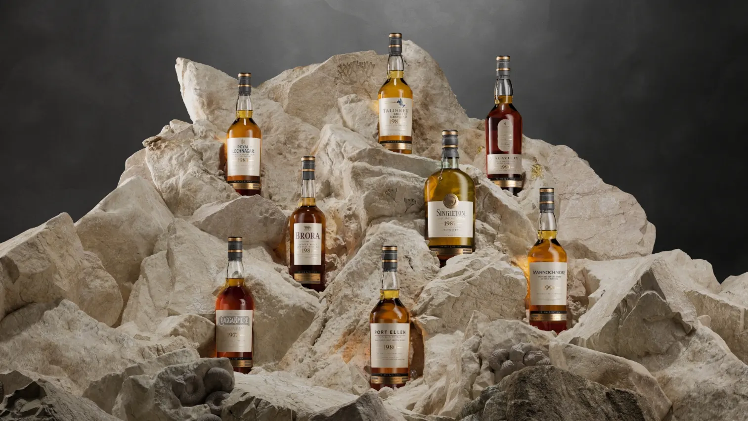 Multiple bottles of whisky displayed on a rocky background