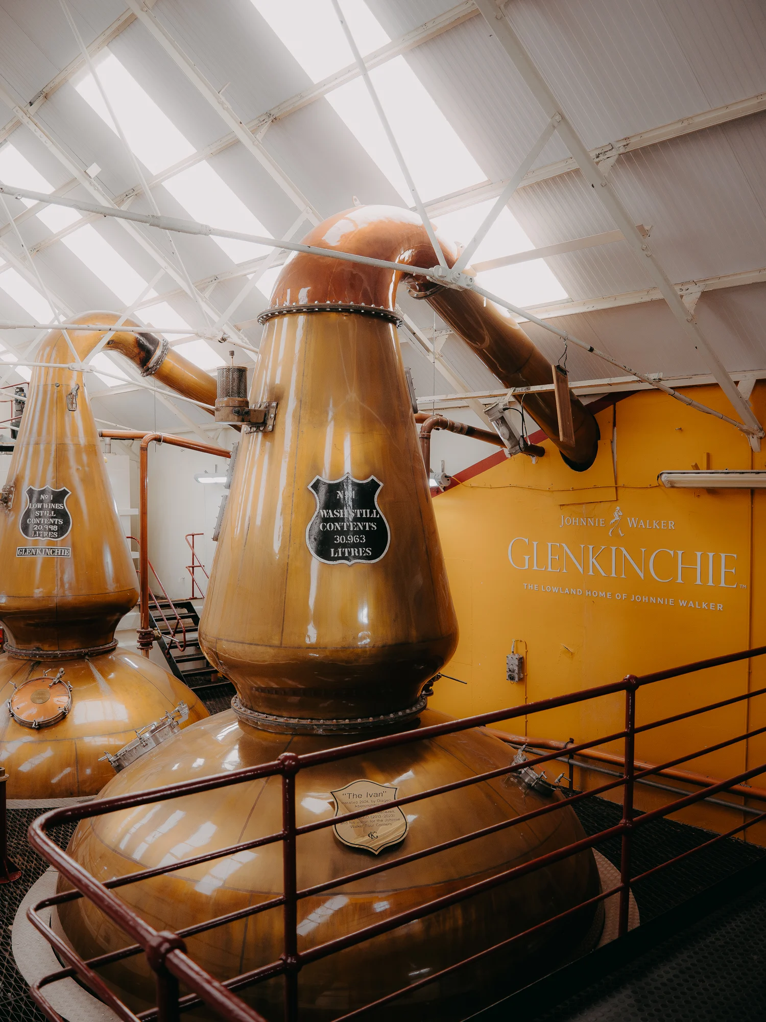 Copper stills and distillery equipment inside a Glenkinchie Distillery.