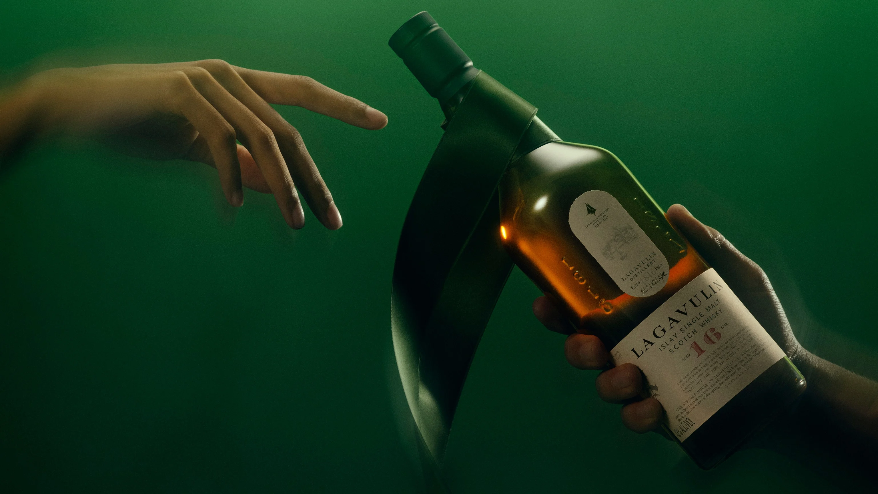 Lagavulin whisky bottle presented in green-tinted light with reaching hands