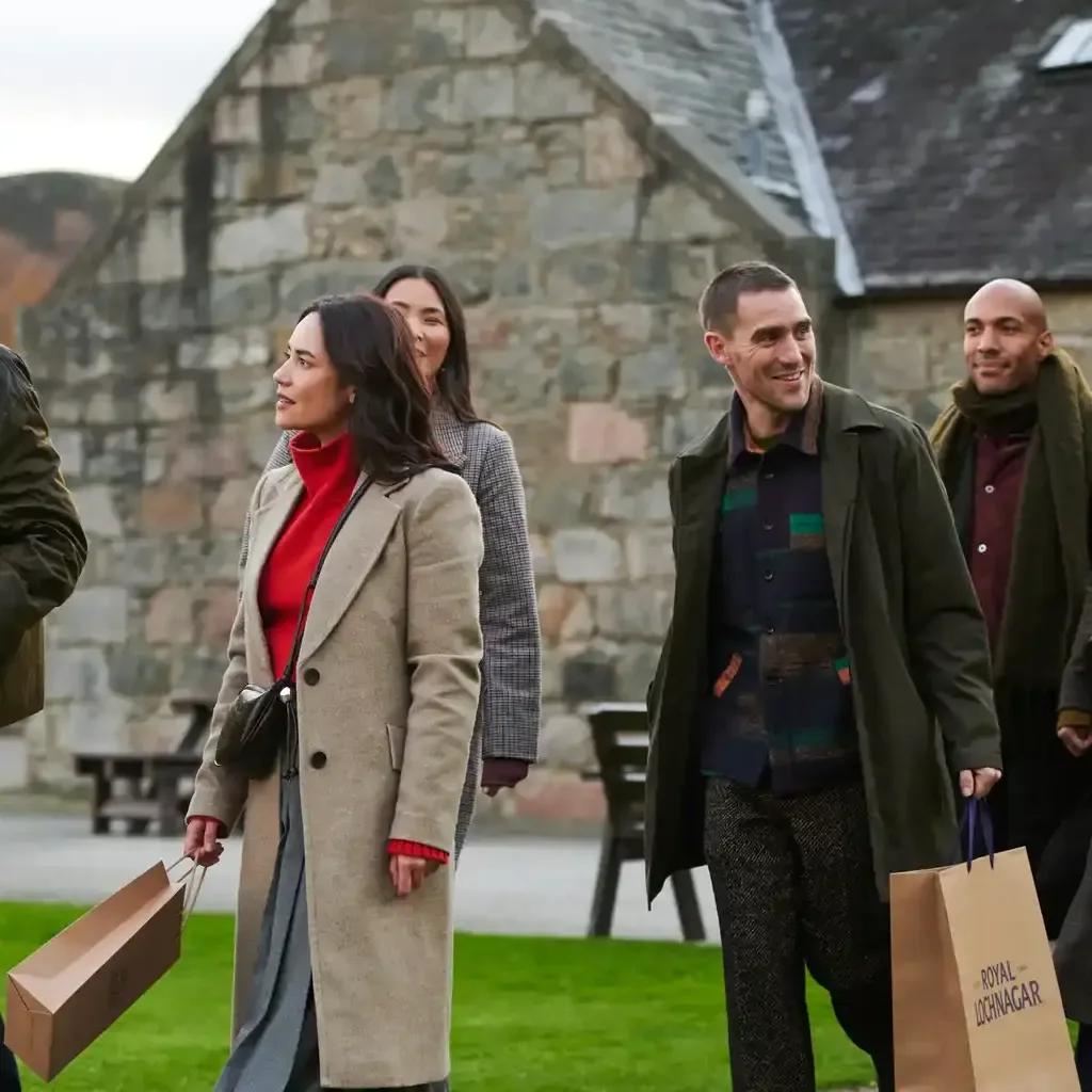 Group of friends with royal lochnagar shopping bags