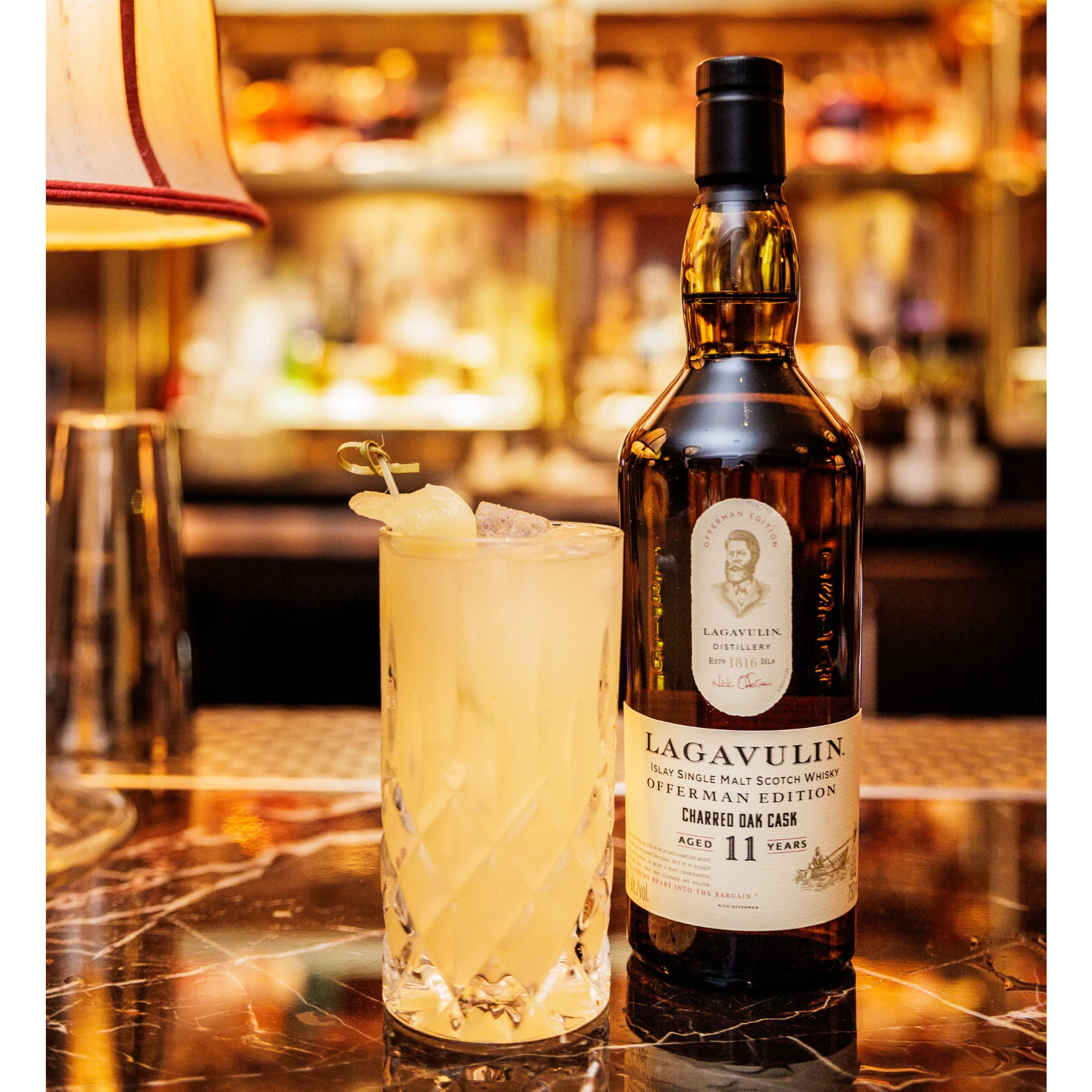 Spirit of Fall highball cocktail next to a bottle of Lagavulin whisky.