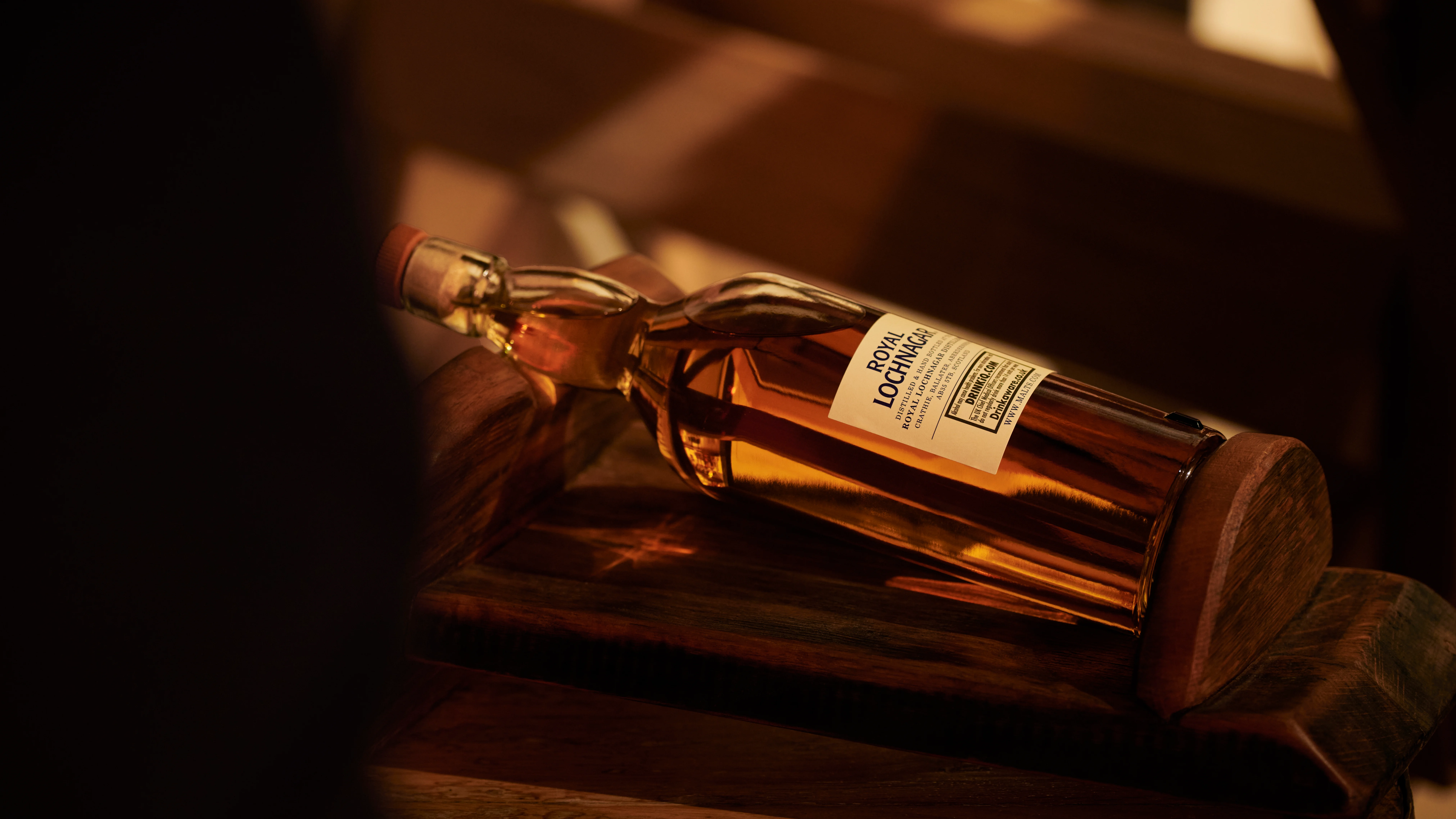 A bottle of Royal Lochnagar whisky lies down on its back