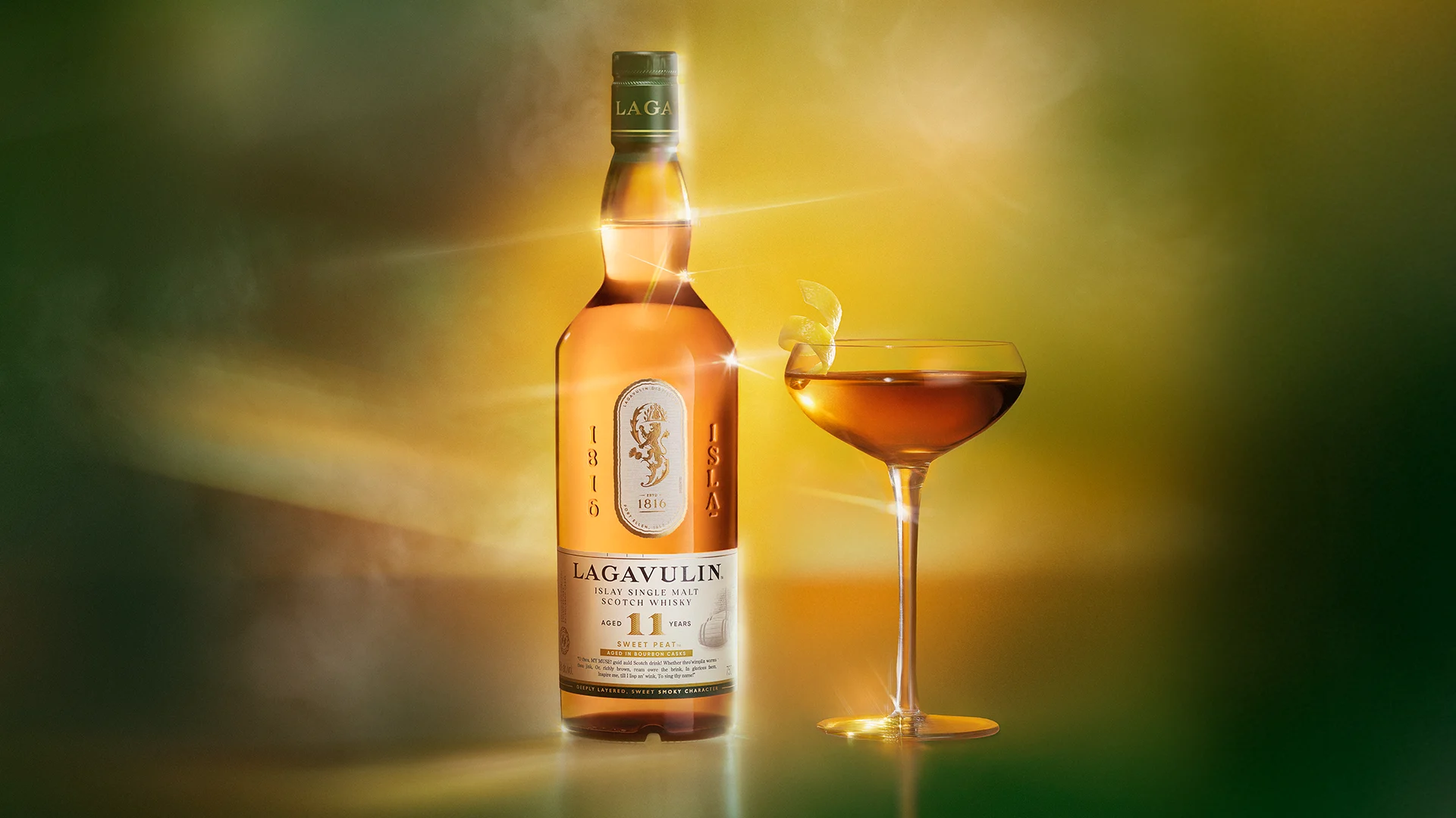 Bottle and glass of Lagavulin 11 Year Old Sweet Peat Islay Single Malt Scotch Whisky, 750ml on green sunrise background