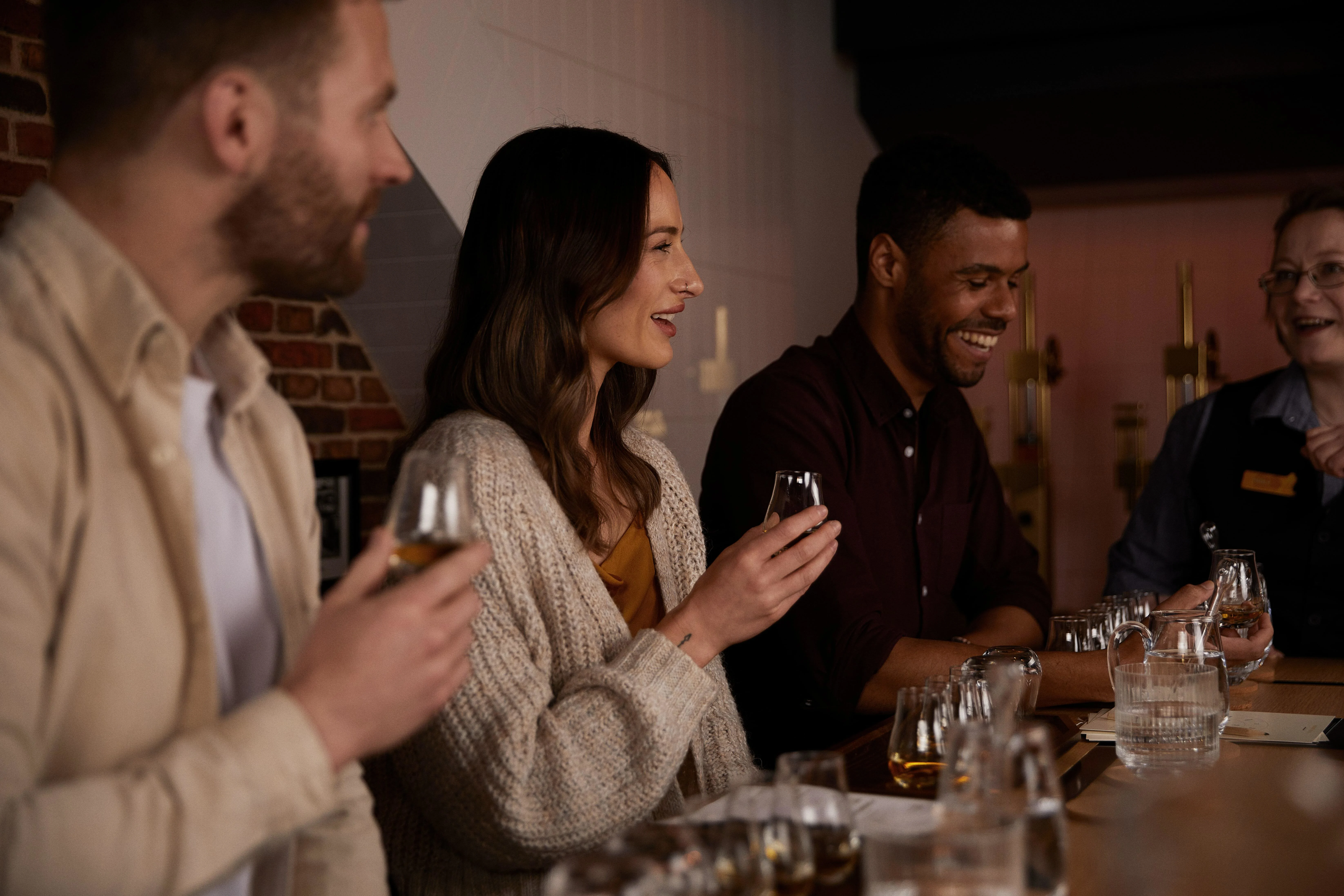 Group of visitors tasting whisky while taking part of the whisky makers cellar experience