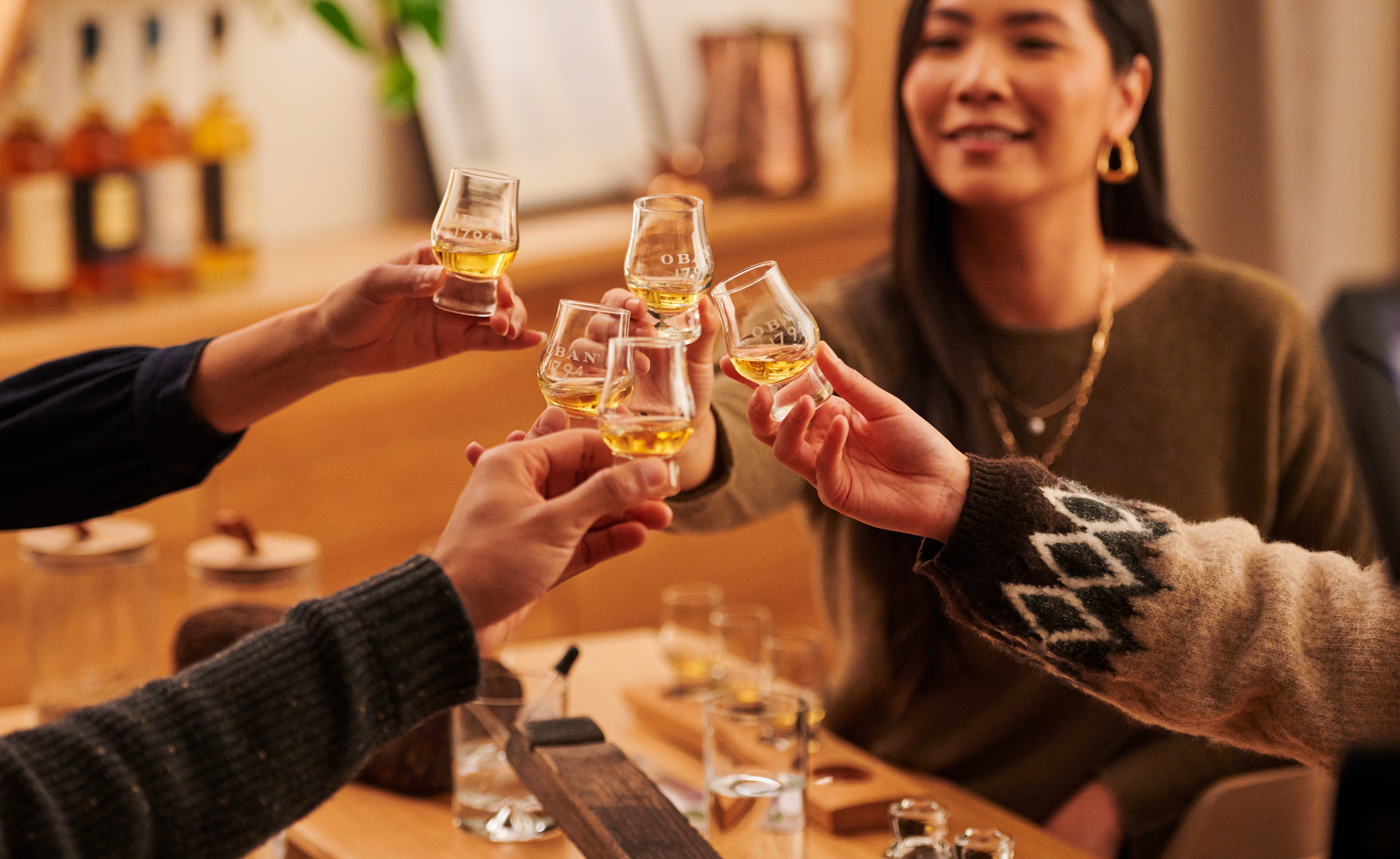 Freunde stoßen mit Whisky-Tasting-Gläsern an