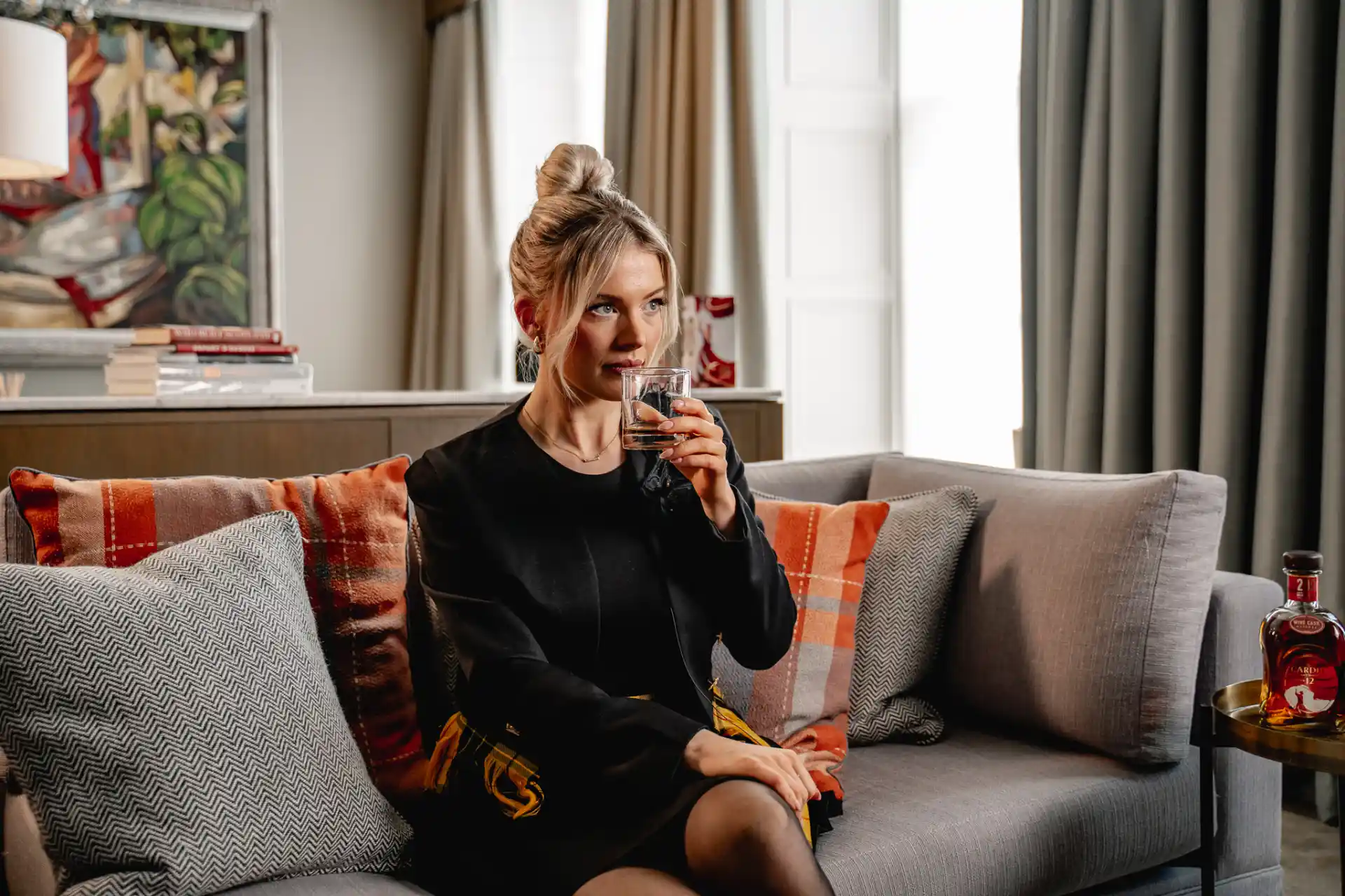 Siobhan Mackenzie drinking Cardhu single malt scotch whisky.