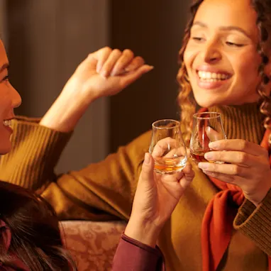 Two women drinking whisky