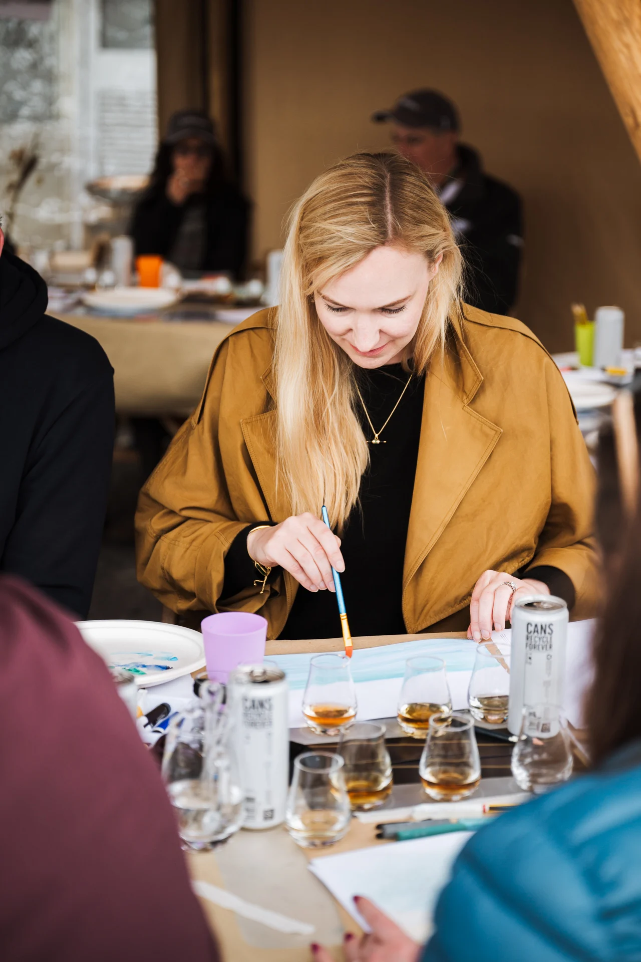 A woman painting during an art class with whisky tasting at Fèis Ìle