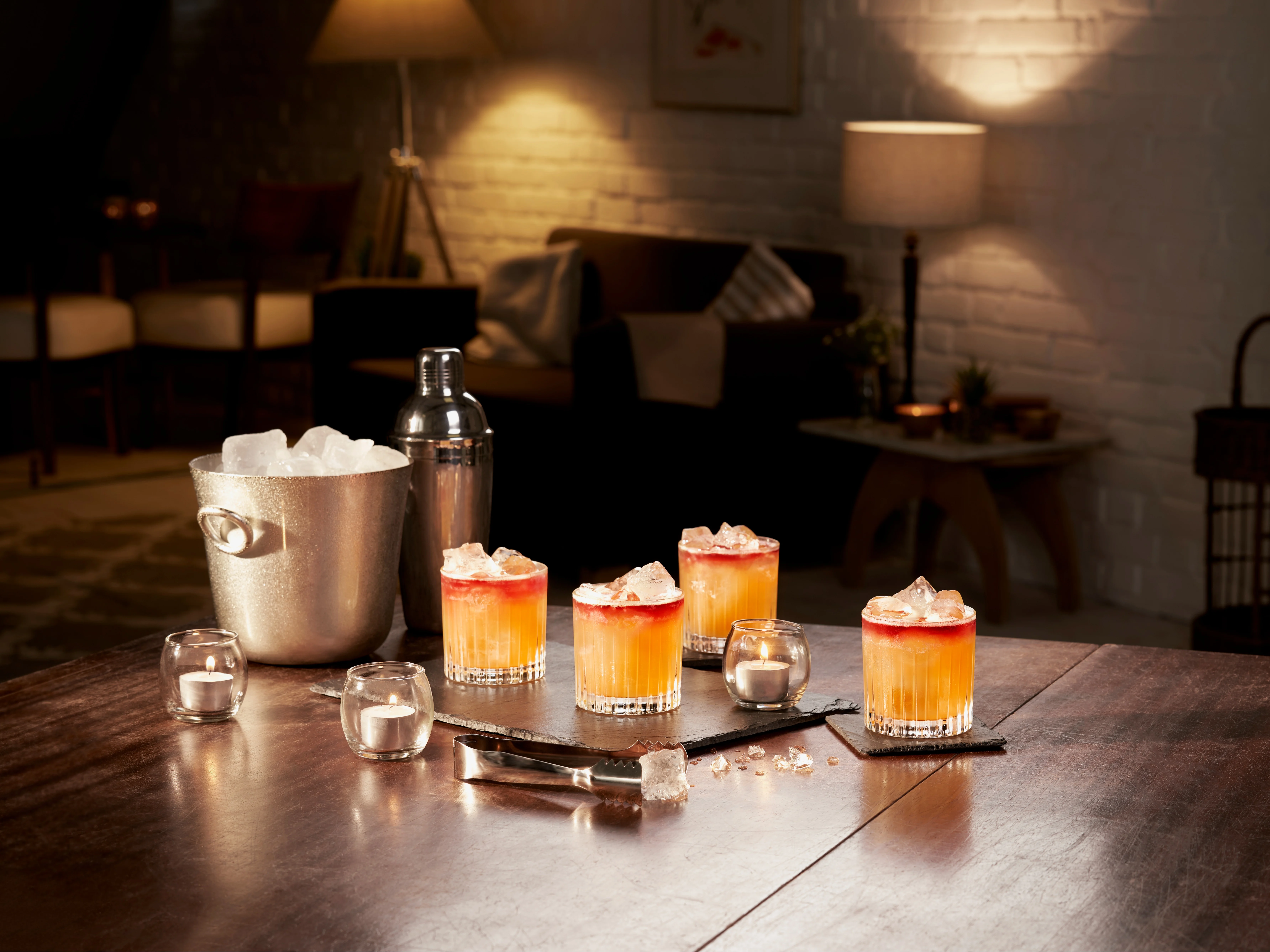 A collection of New York Sour cocktails in rocks glasses on a wooden table
