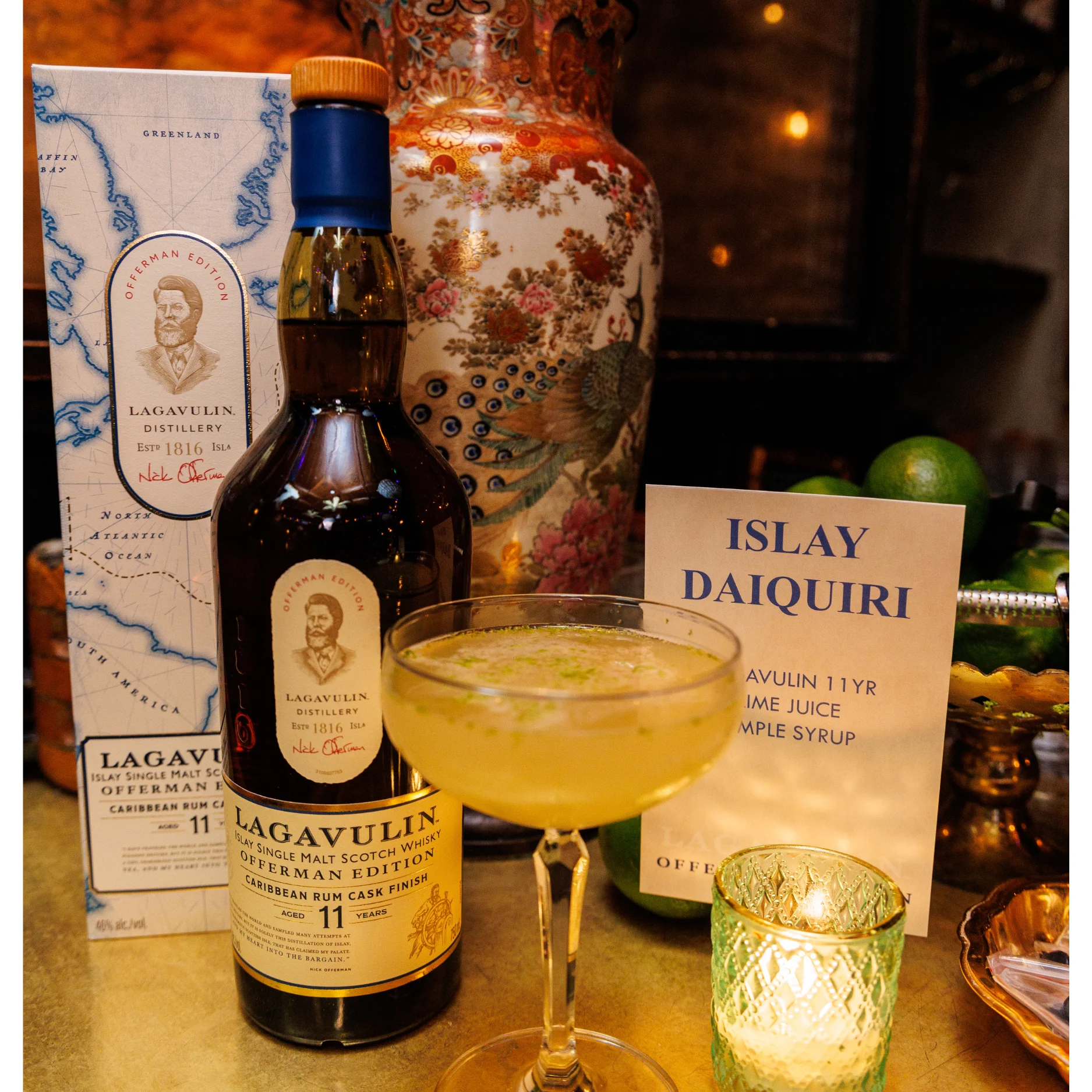 An Islay Daiquiri cocktail next to a bottle of Lagavulin 11 Year Old whisky.  