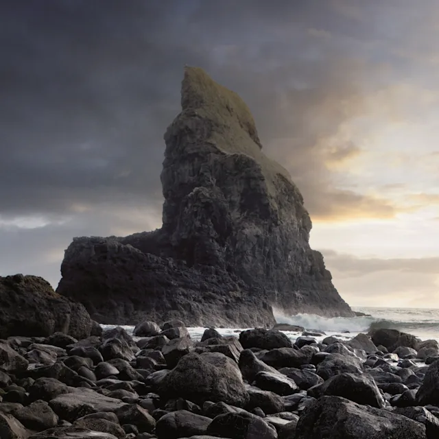A landscape photo capturing mountains and waves in the Isle of Skye