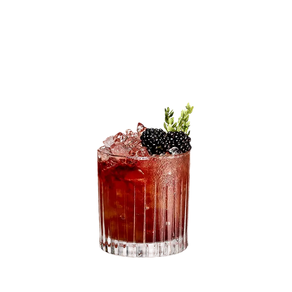 A brown-red cocktail in rocks glass with ice, two blackberries and a green herb sprig garnish