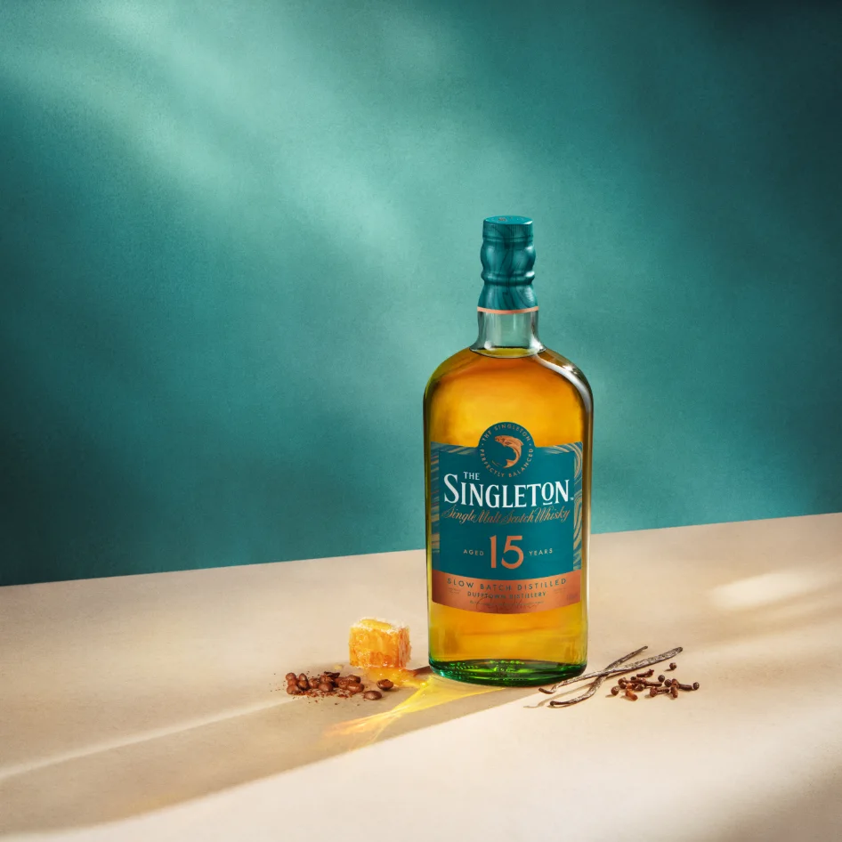 Honey, vanilla, cloves and coffee beans next to a bottle of The Singleton of Dufftown 15 Year Old Single Malt.