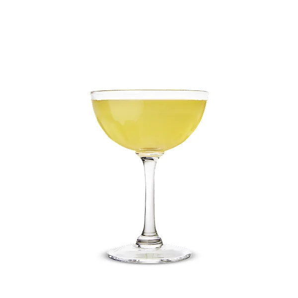 A light yellow cocktail in a coupe glass