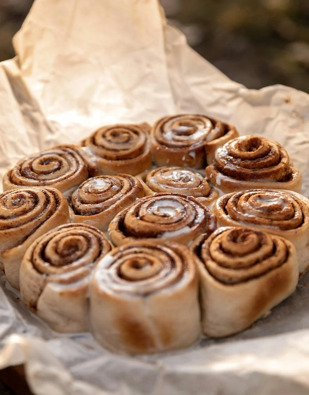 Cinnamon buns on a piece of baking paper.