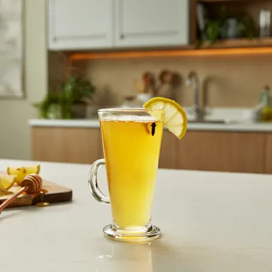 A Hot Toddy cocktail sits on a kitchen counter