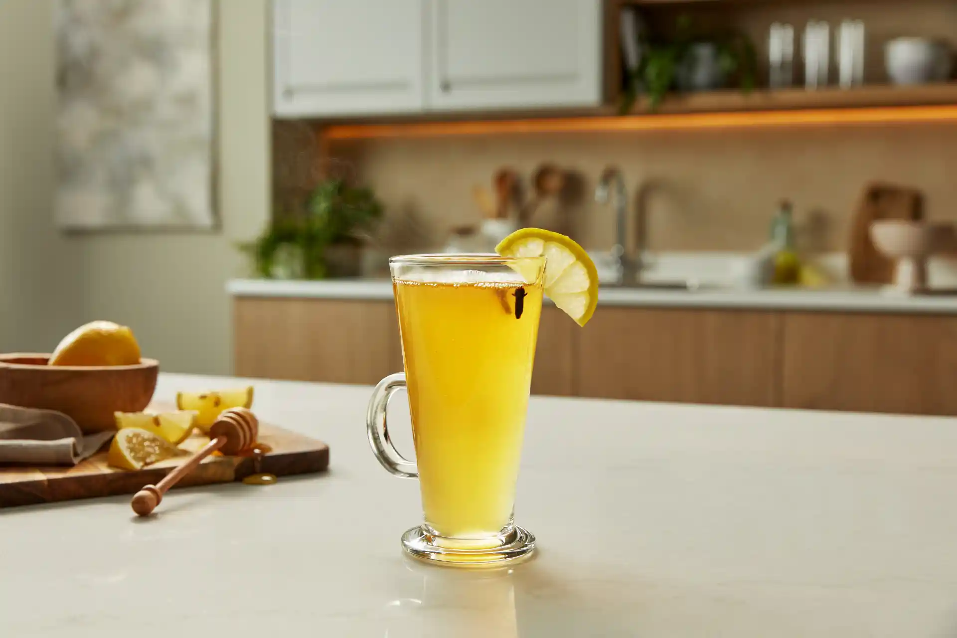 A Hot Toddy cocktail sits on a kitchen counter